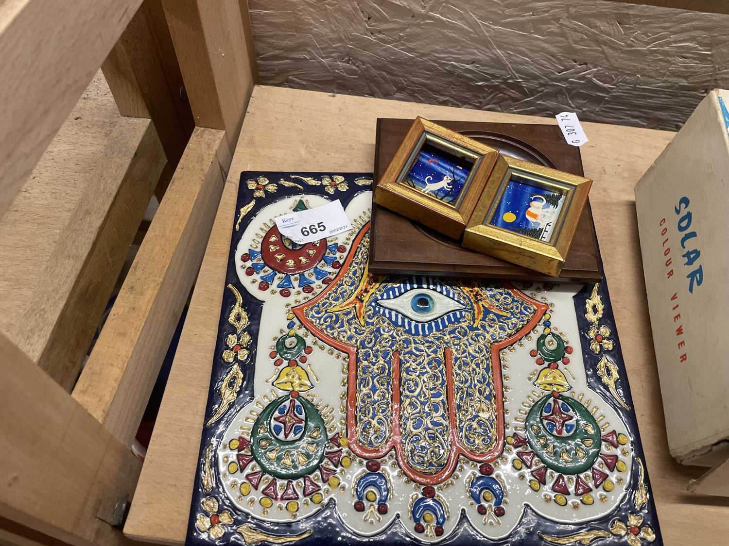 An Egyptian hand painted tile and three small pictures