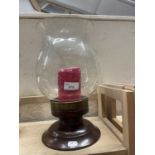 A storm lantern with wooden turned base and engraved decoration to glass lantern