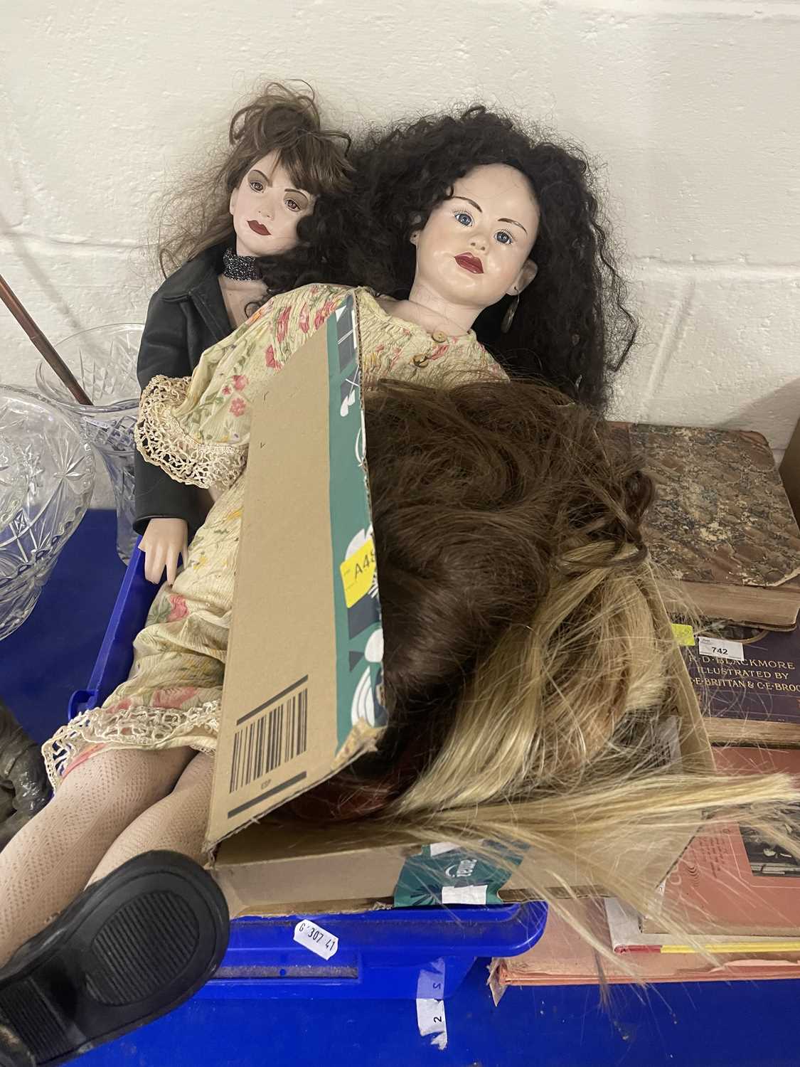 Two dolls and additional hair pieces