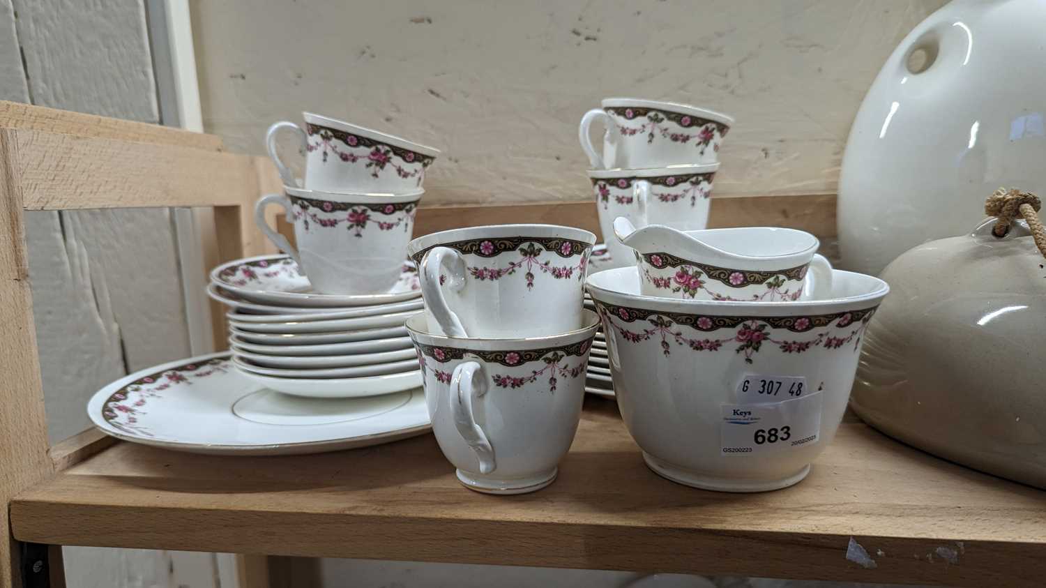 A quantity of pink and green floral decorated tea wares