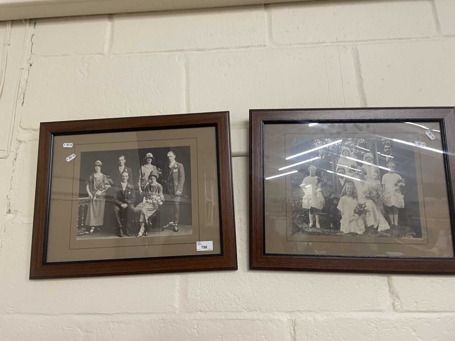 A pair of black and white family wedding photographs, framed and glazed