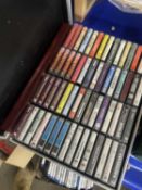 Box of various music cassettes