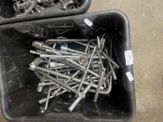 Box of various spark plugs, spanners and others