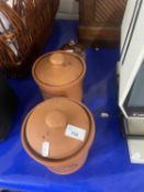 A terracotta tea and coffee canister together with a stone laid marmalade canister