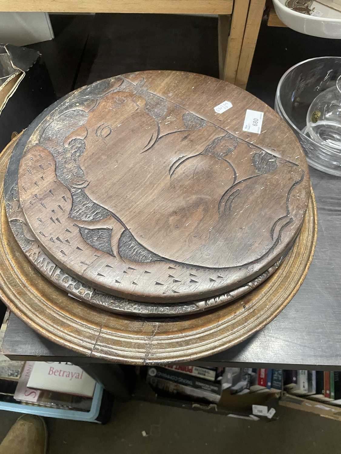 A rustic wooden bowl together with two carved wooden platters