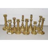 Collection of various antique brass candlesticks to include Ejector examples