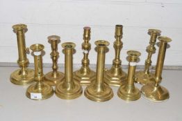 Collection of various antique brass candlesticks to include Ejector examples