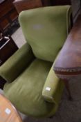 Late 19th or early 20th Century deep seated green upholstered armchair, worn condition