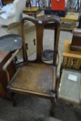 An early 20th Century oak framed carver chair on cabriole legs