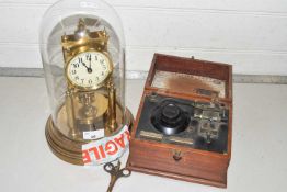 20th Century brass anniversary clock under a glass dome