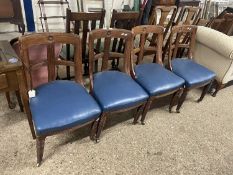 A set of four Victorian oak framed dining chairs with carved floral detail