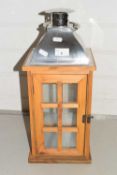 Wooden framed and metal mounted lantern