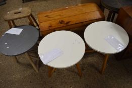 A pair of modern occasional tables with white circular tops together with another similar with a
