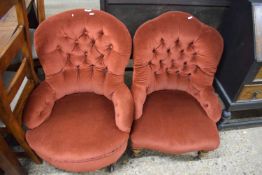 Two similarly upholstered late Victorian button back armchairs