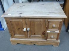 A pine TV cabinet with cupboards below and two drawers, approx 79cm wide