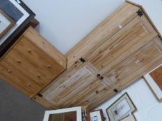 A pine wardrobe and a similar three drawer pine chest of drawers