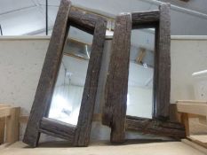 A pair of driftwood framed wall mirrors