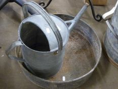 A watering can and aluminium tray