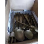 A box of various brass cutlery