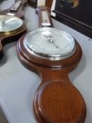 A reproduction oak style barometer with brushed chrome face
