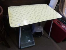 A mid 20th Century yellow laminate topped kitchen dining table