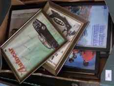 A box of various framed automobilia prints