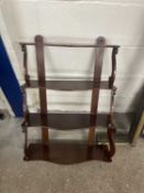 Four tier mahogany wall shelf with scroll supports