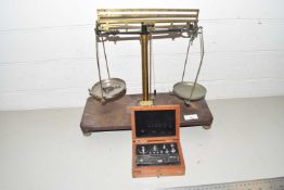 A pair of chemists precision beam scales together with a case of weights