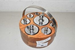 A set of precision weights in wooden stand
