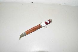 Small knife in leather sheath with red banded handle