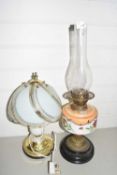 Oil lamp with floral glass font together with a modern metal based table lamp