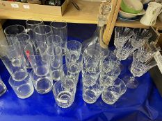 A quantity of mixed glass ware to include wine glasses, tumblers, high balls and a decanter