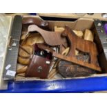 Box of assorted wood carved items and a pair of binoculars