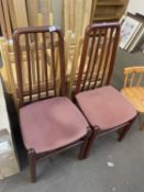 Pair of stained pine dining chairs with upholstered seats
