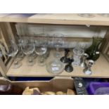 A group of assorted drinking glasses, two pairs of dwarf candlesticks etc