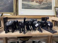 A pair of ebony elephant book ends and other decorative elephants