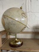 A reproduction 12 inch diameter world globe on brass and turned wood stand