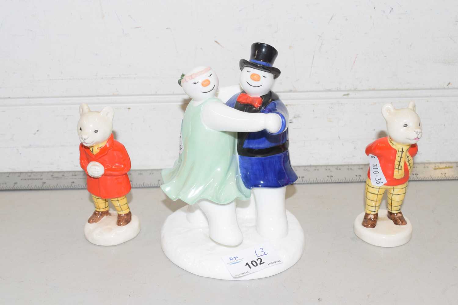 A Coalport snowman figure group together with two Beswick Rupert the Bear figures