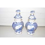 A pair of blue and white covered delft vases