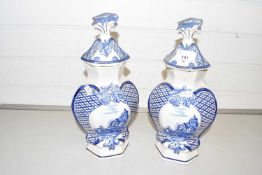 A pair of blue and white covered delft vases