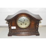 An oak cased mantel clock with barley twist supports