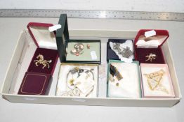 A box of various assorted costume jewellery to include horse brooches