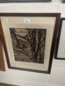 A etching of a woodland scene with cabins and mountains beyond, framed and glazed