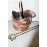 Copper coal helmet and a pair of brass fire tongs