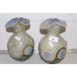 A pair of Royal Doulton stone ware vases decorated with floral design
