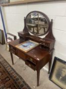 Late 19th or early 20th Century mahogany dressing table with oval mirrored back