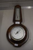 An oak cased barometer and thermometer