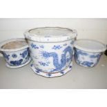 Three 20th Century Chinese blue and white jardinieres decorated with dragons, the largest 40cm