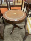 A reproduction leather topped drum style occasional table, 50cm diameter