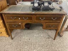 An Edwardian leather topped four drawer writing table, 122cm wide